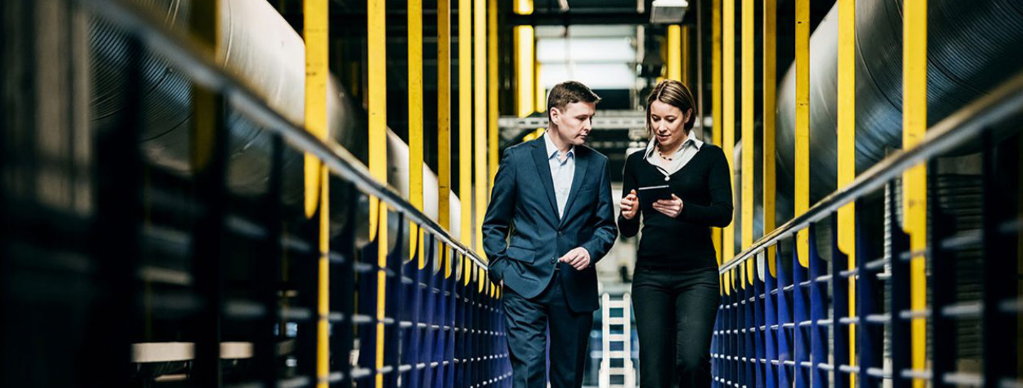 Man and woman walking in warehouse